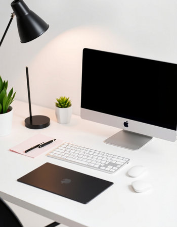 Workplace with computer, stationery and decorations on table in office