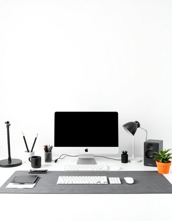 Modern workspace with computer, supplies and coffee cup on white background.