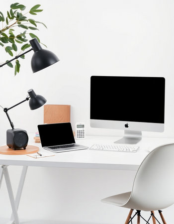 workplace with computer, lamp, camera and chair on white background