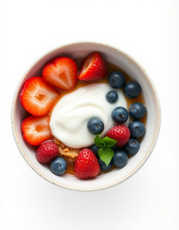 Greek yogurt with fresh berries in a bowl isolated on white background.の写真素材