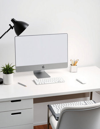 workplace with computer, keyboard, mouse, lamp and other itemsの写真素材