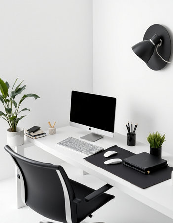 workplace with computer, keyboard, mouse, lamp and green plantの写真素材