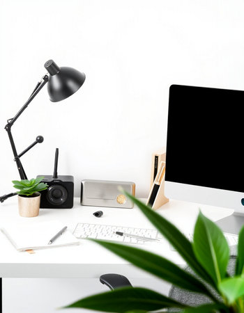 Minimalist workspace with computer, keyboard, mouse, coffee cup, camera, stationery and copy space on white backgroundの写真素材