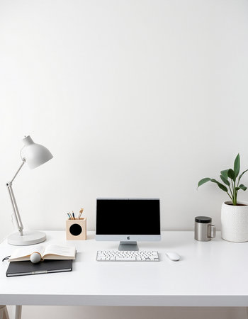 workplace with laptop, stationery, coffee cup and plant on tableの写真素材