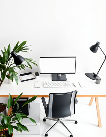 Modern workspace with computer, laptop, tablet, mobile phone and plant.の写真素材