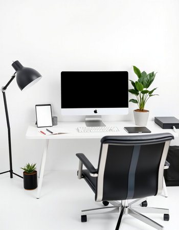 Modern workplace with computer, smartphone and office supplies.の写真素材