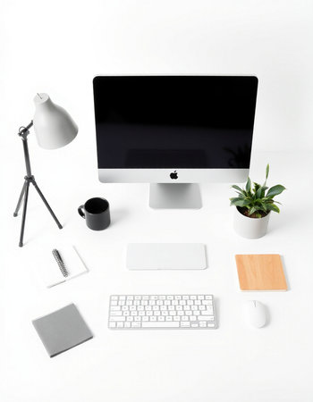Modern workspace with computer, keyboard, mouse, stationery and coffee cup on white backgroundの写真素材