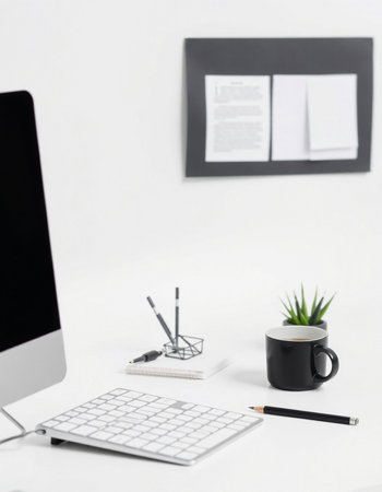 Office workplace with computer, supplies and coffee cup on white background.の写真素材