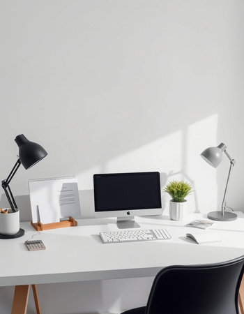 workplace with computer, lamp, stationery and plant on tableの写真素材