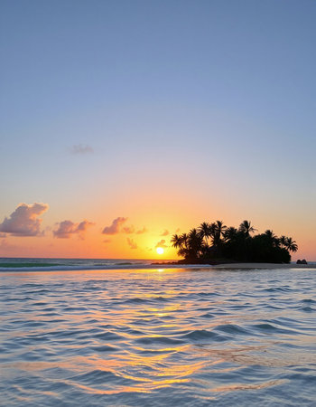 Beautiful sunset over a tropical island with palm trees in the oceanの写真素材