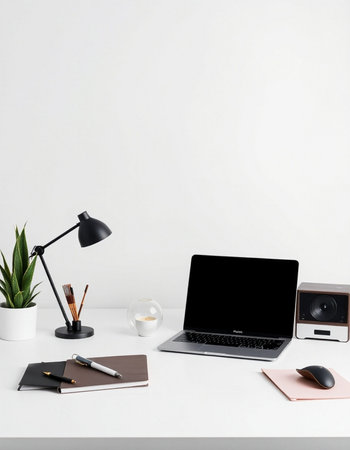 workplace with laptop, stationery and coffee cup on white tableの写真素材