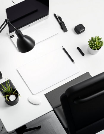 Top view of modern office desk with blank paper, laptop, coffee cup and other items. Mock upの写真素材