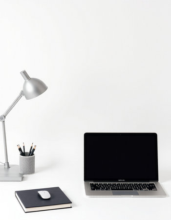 Modern workspace with laptop, notebook, stationery and lamp on white backgroundの写真素材