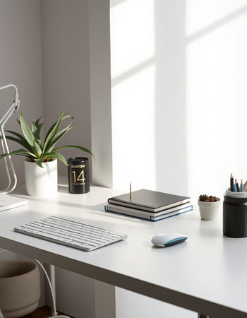White office desk with laptop, stationery and plant.の写真素材