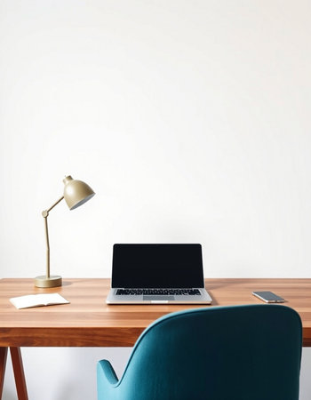 workplace with laptop, lamp and coffee cup on white wall backgroundの写真素材