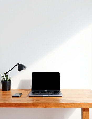 Laptop with blank screen on wooden table and white wall background.の写真素材