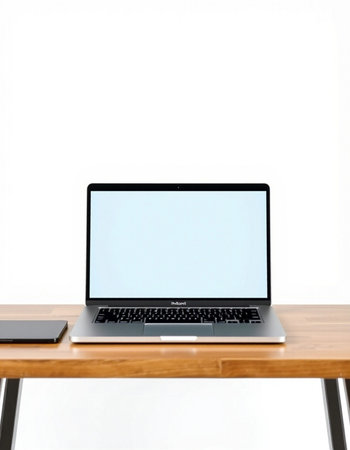 Laptop with blank screen on wooden table isolated on white background.の写真素材