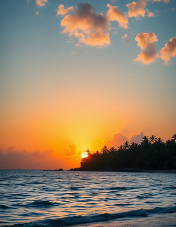 Beautiful sunset on the beach with palm trees and turquoise seaの写真素材