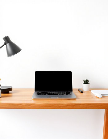 Laptop with blank screen on wooden table and white wall background.の写真素材