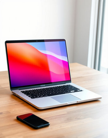 Laptop with colorful screen on a wooden table in the office.