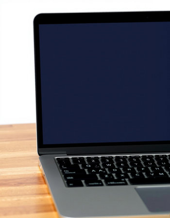 Laptop on a wooden table against a white background with copy spaceの写真素材
