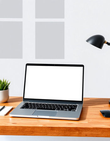 Modern workspace with blank screen laptop computer, coffee cup and other items on wooden table in office. Mock upの写真素材