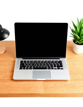 Laptop with blank screen on wood desk isolated on white background.