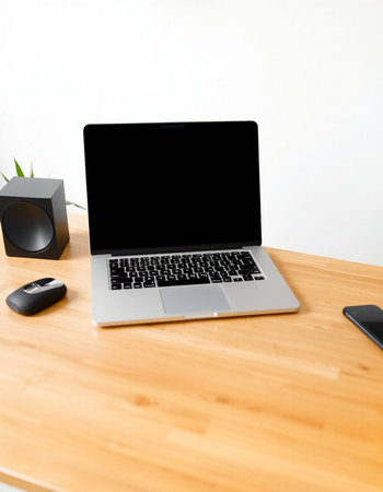 laptop with blank screen on wood desk and speaker on white background