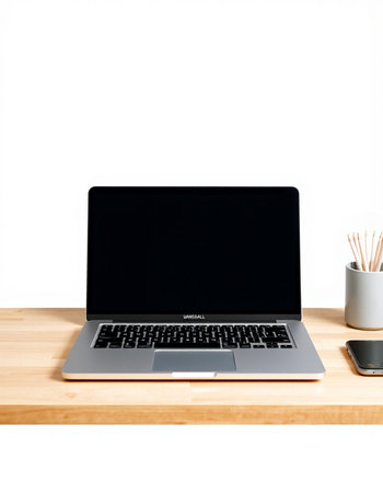 Laptop computer with blank screen on wooden table isolated on white background