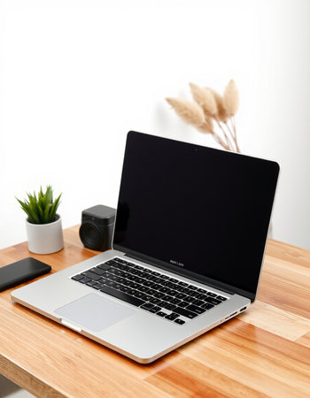 Laptop computer with blank screen on wooden desk with copy space, stock photo