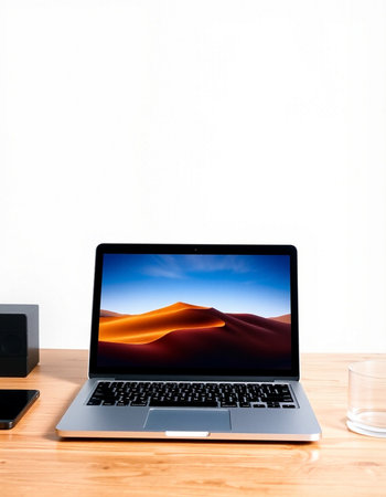 Laptop on wooden table with white wall background and copy space.
