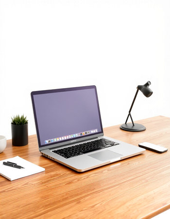 Laptop on the desk with lamp and mobile phone on white background