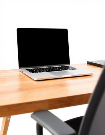 Laptop with blank screen on wooden desk isolated on white background.