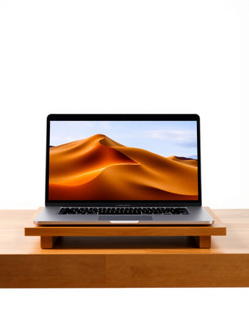 Laptop with sand dunes on table isolated on white background.