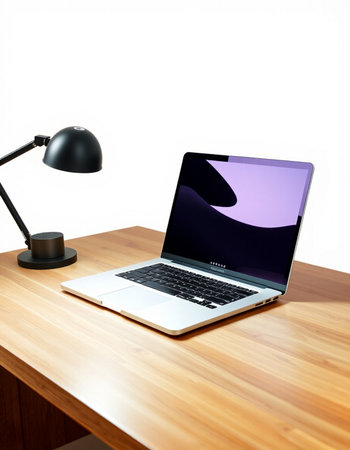 Laptop on a wooden desk with a lamp and a white background