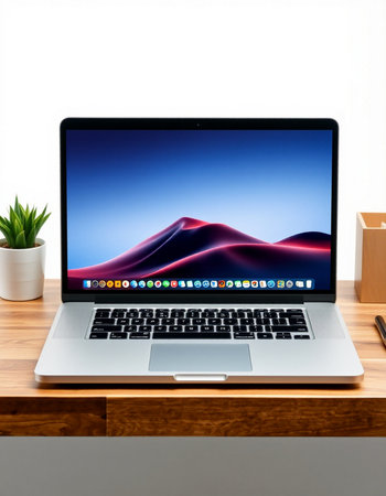 Laptop on the wooden table with a white wall and a plant