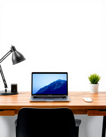 workplace with laptop, lamp and plant on wooden table isolated on white backgroundの写真素材