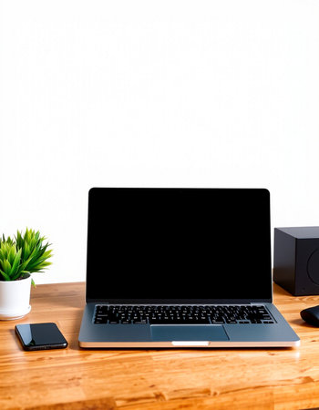 Laptop with blank screen on wood table and white wall background.
