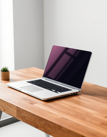 laptop with blank screen on wooden table in office, mockupの写真素材