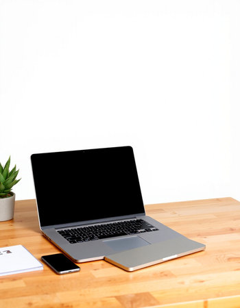 Laptop with blank screen on wooden table and white wall background.の写真素材