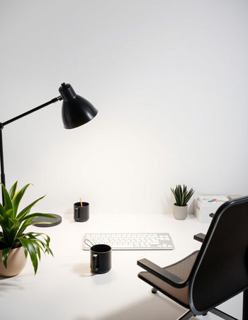 workplace with computer, coffee cup and plant on table in office