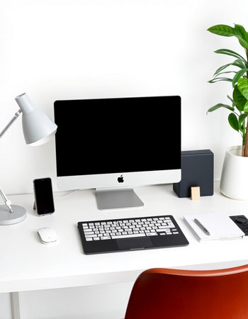 workplace with computer, keyboard, mouse, lamp, coffee cup and plant