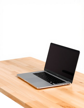 Laptop computer on wood table isolated on white background with clipping path