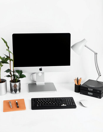 Modern workspace with computer, keyboard, mouse and office supplies on white backgroundの写真素材