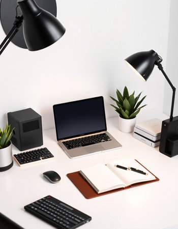 Workplace with laptop, stationery and notebook on table in office
