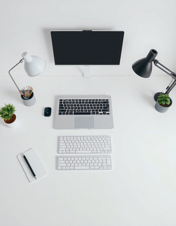 Top view of modern workplace with computer, supplies and decorations on white backgroundの写真素材