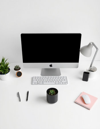 Modern workspace with computer, stationery and coffee cup on white backgroundの写真素材