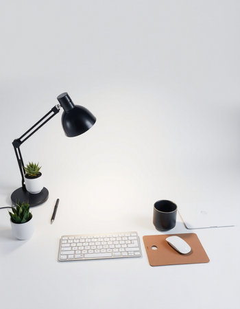 Office desk with keyboard, mouse, coffee cup and potted plant
