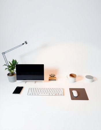 Minimalistic workspace with keyboard, mouse, coffee cup and notebook on white backgroundの写真素材