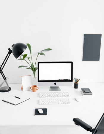 workplace with computer, lamp and stationery on white wall background